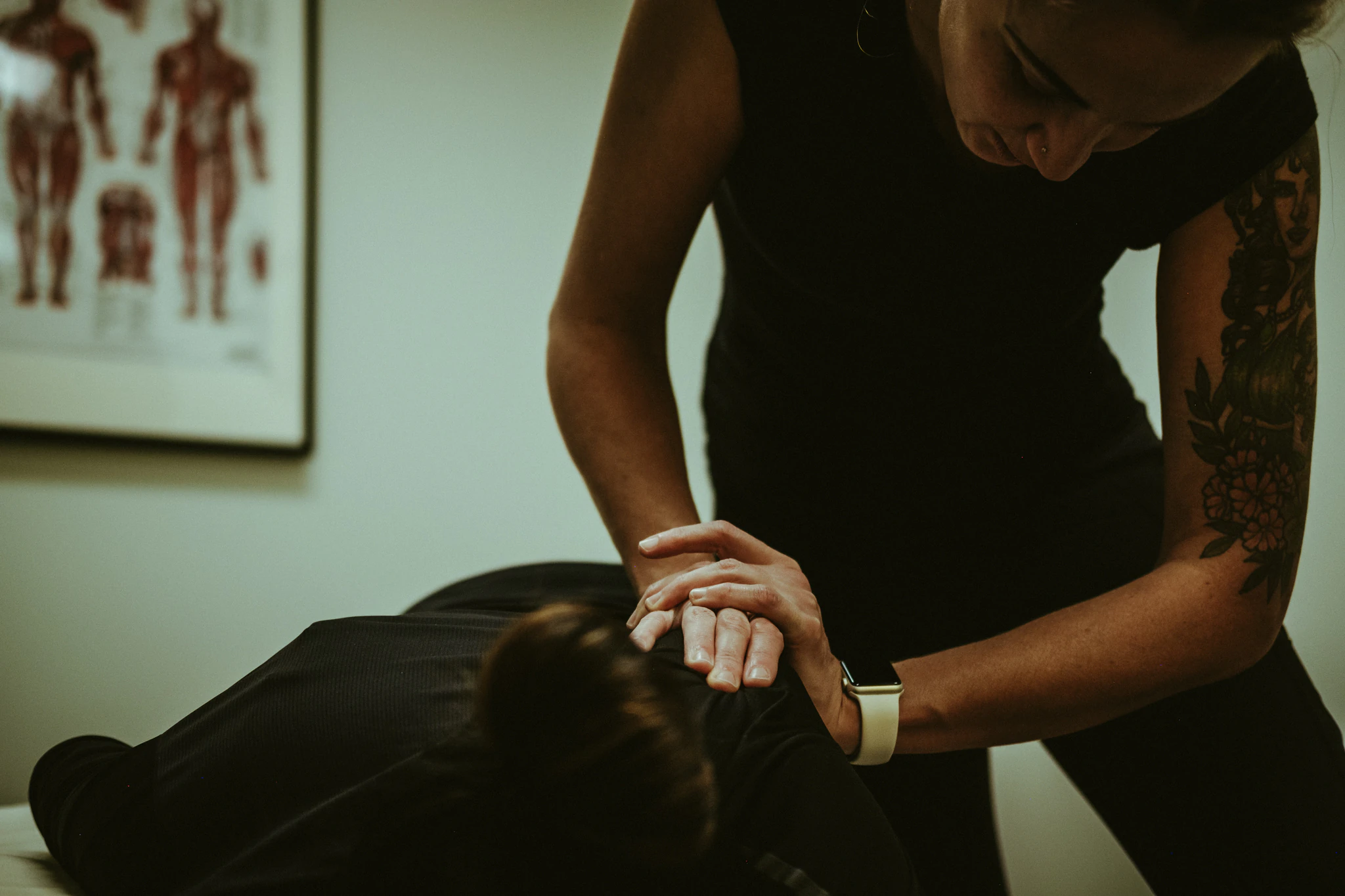 Aneta performing Active Release Techniques® on a client’s shoulder during a hands-on treatment