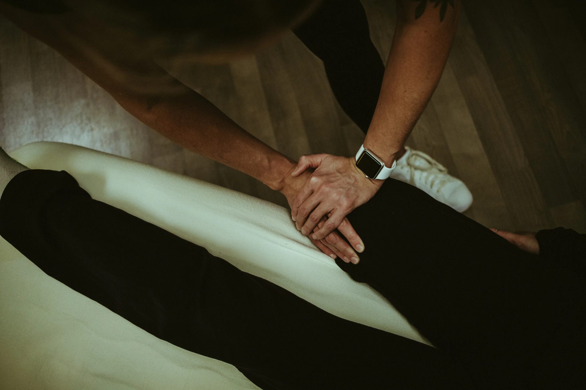ART® treatment on the lower body, showing hands-on soft-tissue work at the treatment table