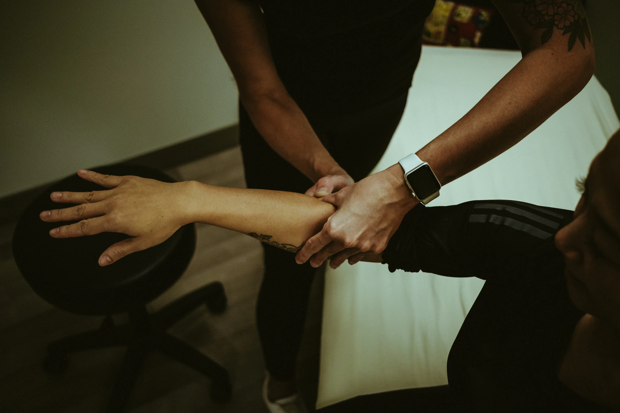Aneta treating a client’s forearm on the treatment table during an ART® session